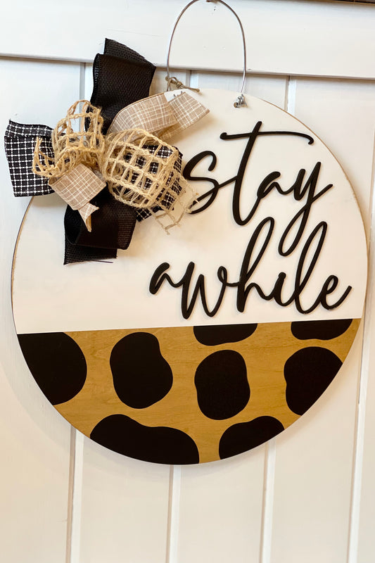 Stay Awhile Cow Print Door Hanger