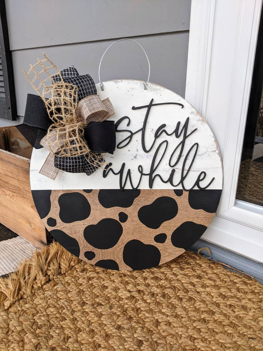 Stay Awhile Cow Print Door Hanger